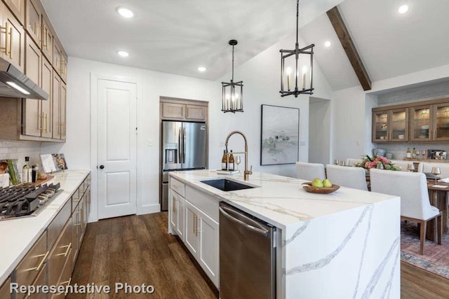 kitchen featuring stainless steel appliances, a spacious island, sink, decorative light fixtures, and dark hardwood / wood-style floors