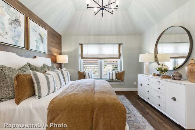 bedroom featuring an inviting chandelier, dark wood-type flooring, and vaulted ceiling