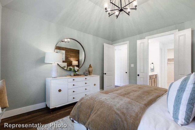 bedroom featuring a notable chandelier, dark hardwood / wood-style flooring, connected bathroom, and vaulted ceiling