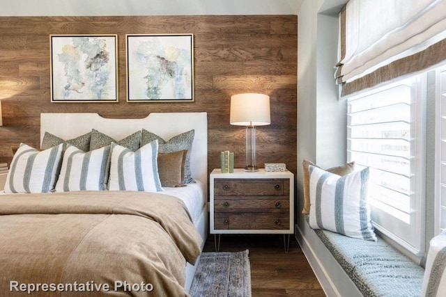 bedroom with dark hardwood / wood-style flooring