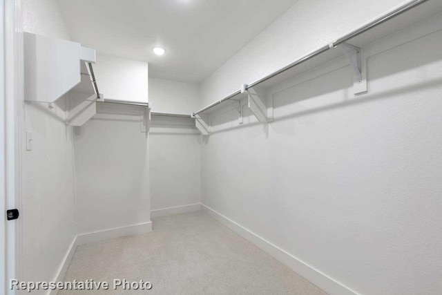 spacious closet with light colored carpet