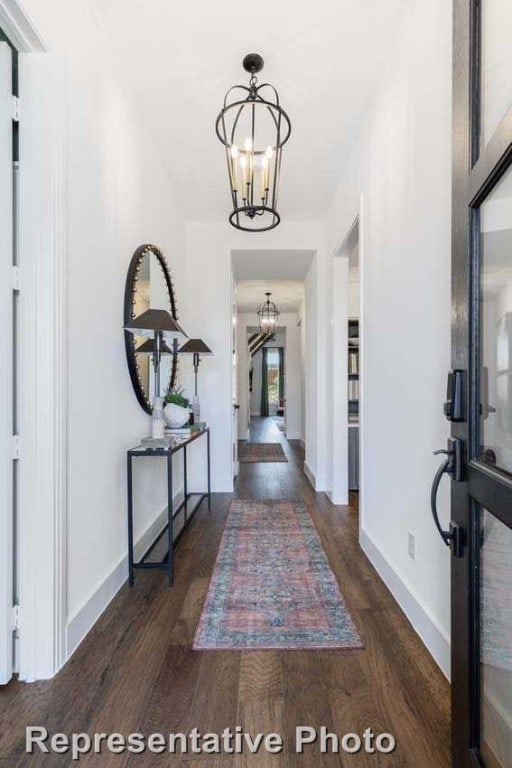 entrance foyer with dark wood-type flooring and a notable chandelier