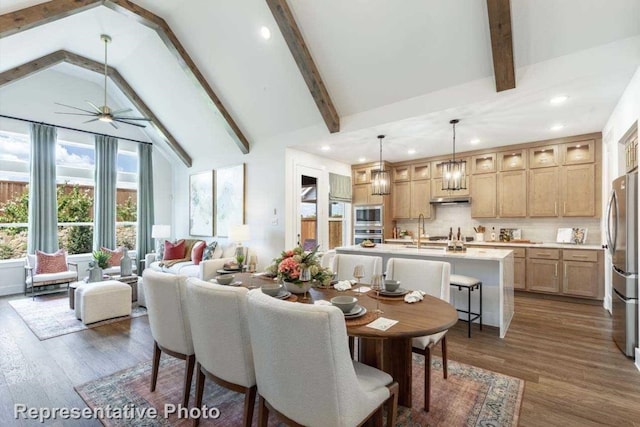 dining area featuring ceiling fan, beamed ceiling, and dark hardwood / wood-style floors