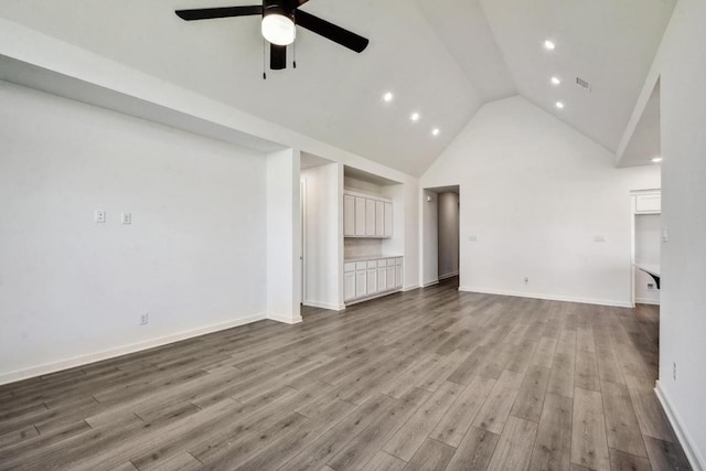 564 Biscayne Bay Bnd, Kyle, TX 78640 - unfurnished living room featuring ceiling fan, high vaulted ceiling, wood finished floors, recessed lighting, and baseboards