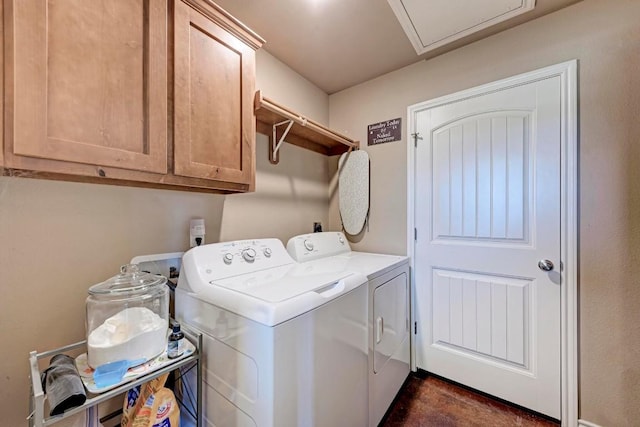 washroom with washer and dryer and cabinets