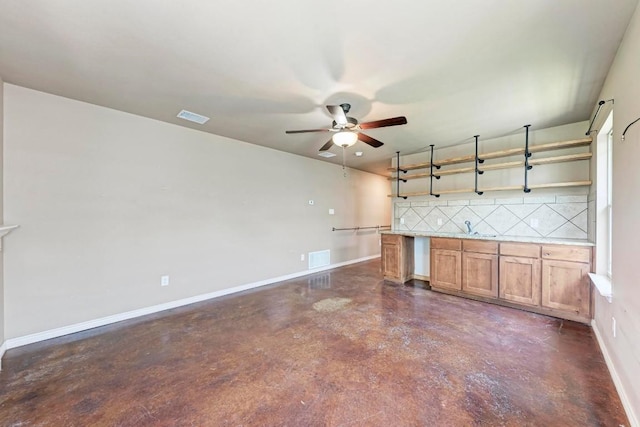 kitchen with decorative backsplash, ceiling fan, and sink