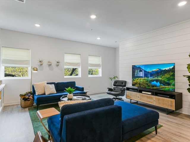 living room with a wealth of natural light and light hardwood / wood-style flooring