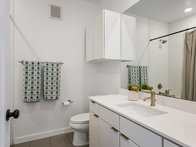 bathroom featuring a shower with curtain, tile patterned floors, toilet, and vanity