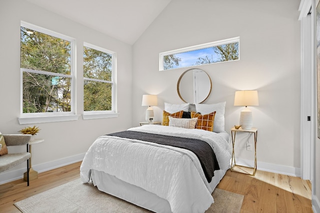 bedroom featuring vaulted ceiling and light wood-type flooring