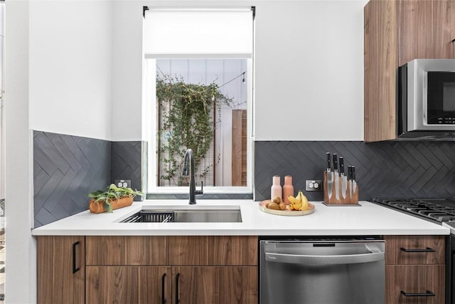 kitchen with stainless steel appliances, tasteful backsplash, and sink