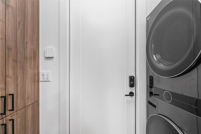 laundry room with stacked washer / drying machine