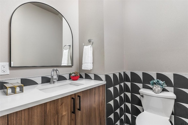 bathroom with decorative backsplash, vanity, and toilet