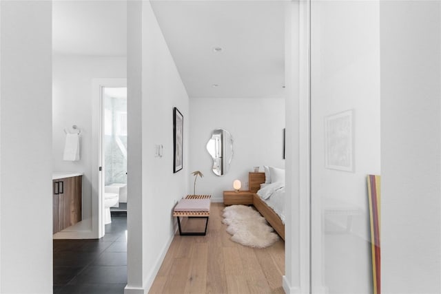 bathroom with vanity, toilet, and wood-type flooring