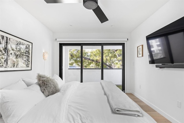 bedroom featuring hardwood / wood-style floors, ceiling fan, and access to outside