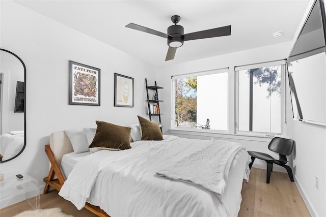 bedroom with light wood-type flooring and ceiling fan