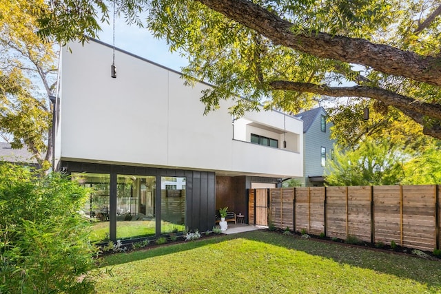 rear view of property with a yard