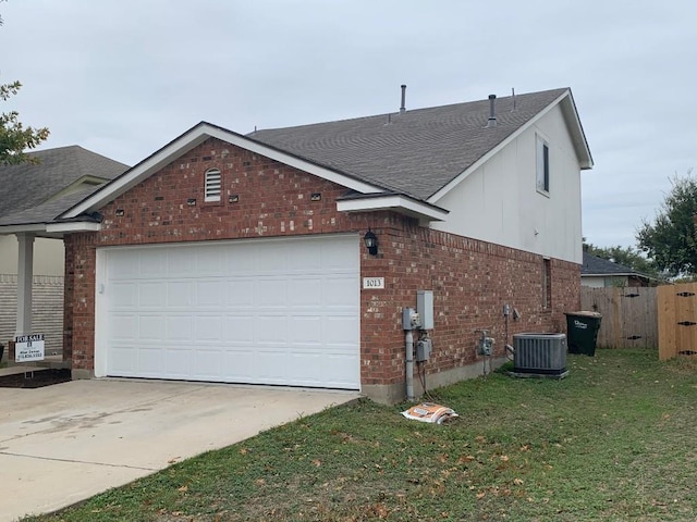 view of front of house featuring a garage and central air condition unit