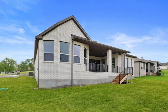 exterior space featuring brick siding and a yard