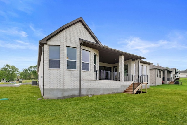 121 Albatross Cv, Cedar Creek, TX 78612 - rear view of house with brick siding and a yard