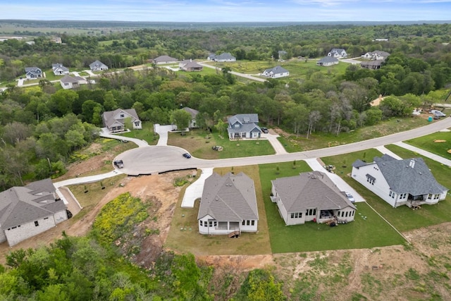 bird's eye view featuring a forest view and a residential view