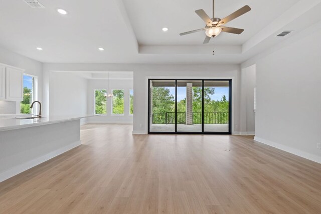 121 Albatross Cv, Cedar Creek, TX 78612 - unfurnished living room featuring healthy amount of natural light, a sink, light wood finished floors, baseboards, and recessed lighting