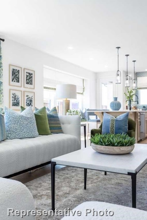 living room with a wealth of natural light and light hardwood / wood-style flooring