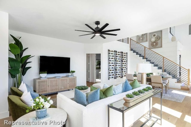 living room with ceiling fan and hardwood / wood-style floors