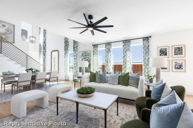 living room featuring ceiling fan and light wood-type flooring