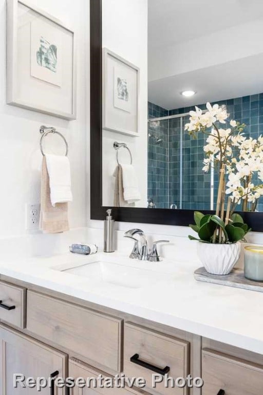 bathroom with vanity and an enclosed shower