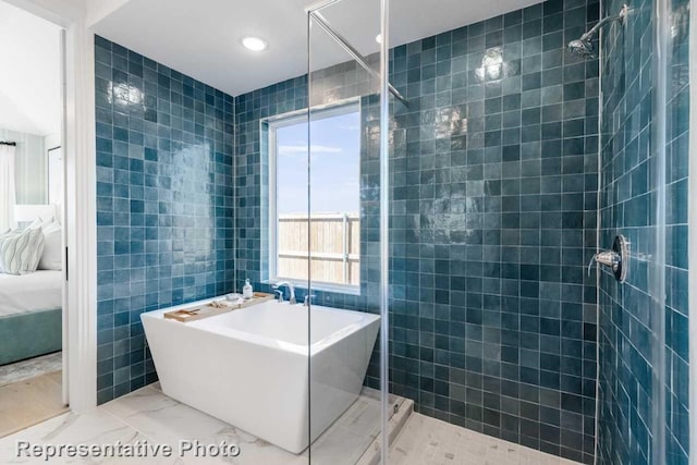 bathroom with plus walk in shower and tile walls