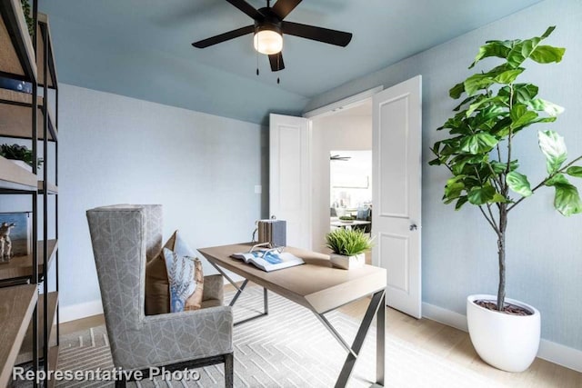 home office featuring ceiling fan and light hardwood / wood-style floors