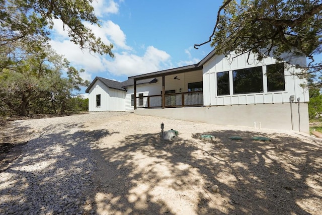 rear view of house featuring ceiling fan