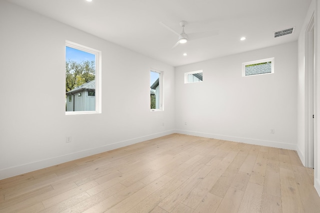 spare room featuring ceiling fan and light hardwood / wood-style flooring