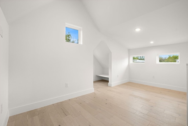 bonus room featuring light hardwood / wood-style floors and vaulted ceiling