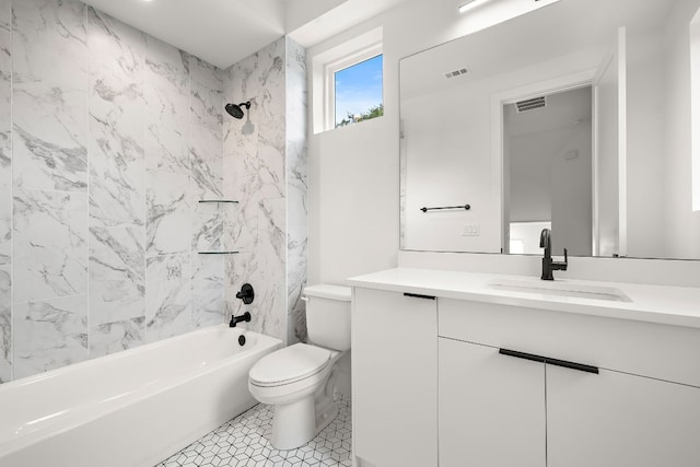 full bathroom with tile patterned floors, tiled shower / bath combo, toilet, and vanity