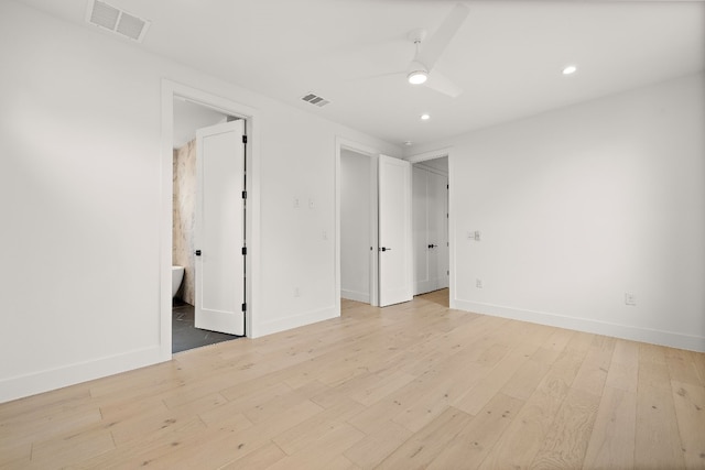 empty room featuring ceiling fan and light hardwood / wood-style flooring