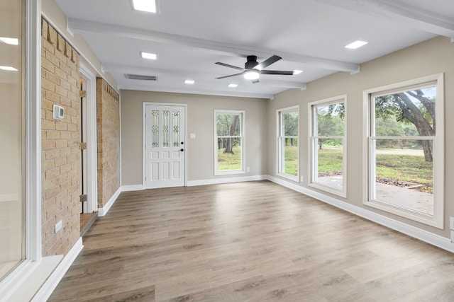 unfurnished sunroom with beam ceiling and ceiling fan