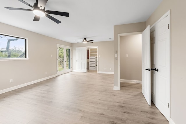 spare room with light hardwood / wood-style flooring and french doors