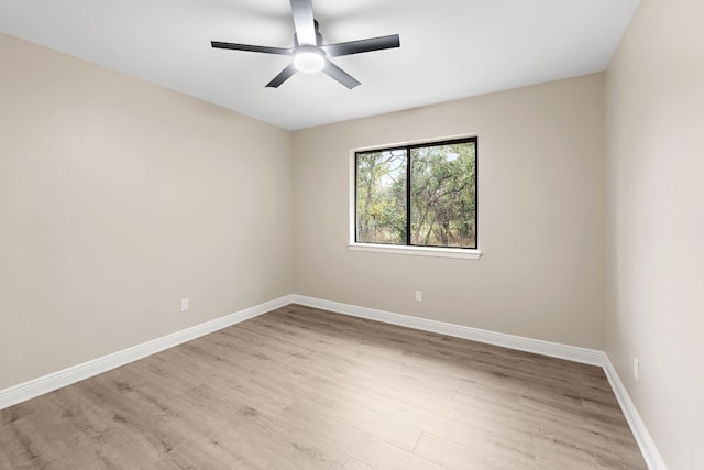 empty room with ceiling fan and light hardwood / wood-style flooring