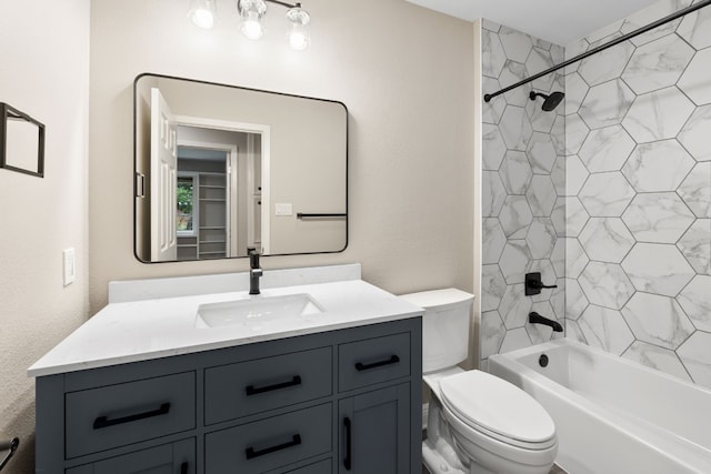 full bathroom featuring vanity, toilet, and tiled shower / bath