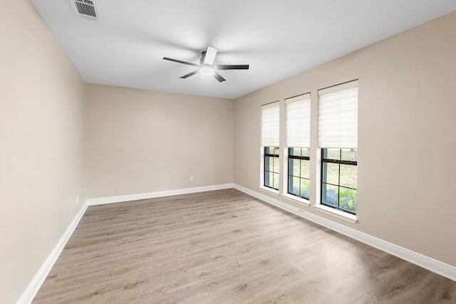 spare room featuring light hardwood / wood-style flooring and ceiling fan