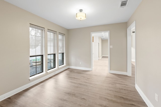 spare room featuring light hardwood / wood-style flooring