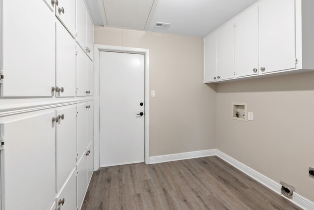 laundry room featuring cabinets, hookup for a washing machine, light hardwood / wood-style floors, and hookup for an electric dryer