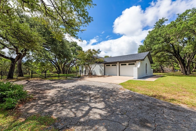 view of front of house with a garage and a front lawn