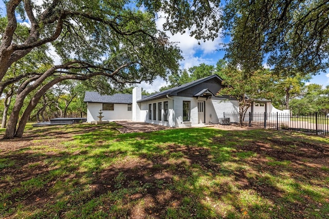 back of property featuring a patio area and a yard