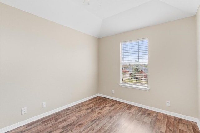 unfurnished room with lofted ceiling and wood-type flooring