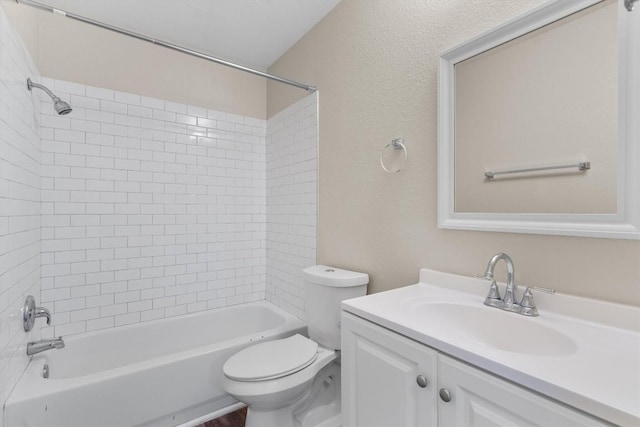 full bathroom with toilet, vanity, and tiled shower / bath