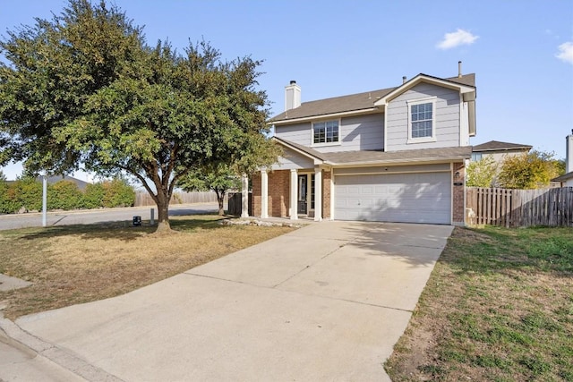 view of front of house featuring a front yard and a garage