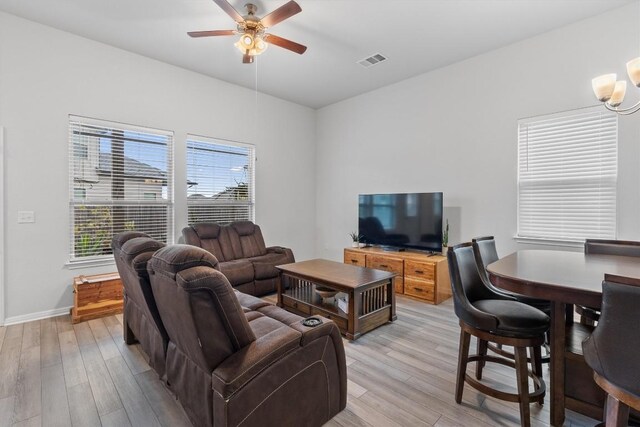 living room featuring light hardwood / wood-style flooring and ceiling fan