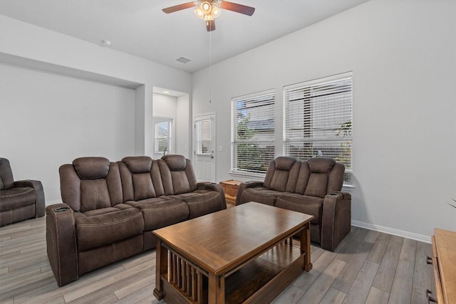 living room with ceiling fan and light hardwood / wood-style flooring